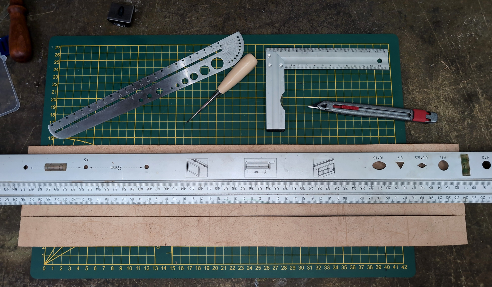 Cutting along the line, guided by a big ruler